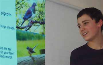 Photo of Gabriel McMurren with pictures of New Zealand birds