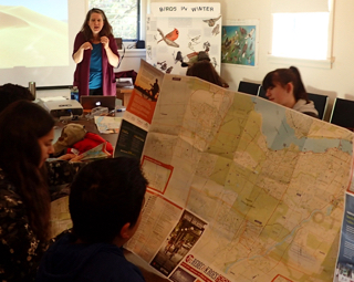 Photo of Macoun Club leader Jen Line teaching map-reading skills