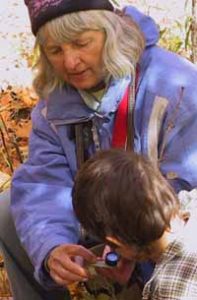 Photo of Barbara Gaertner instructing Macoun Club member in use of a hand lens