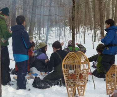 Photo of Macoun Field Club group at lunch, snowshoes standing on end in the snow