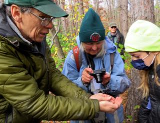 Photo of Rob attracting attention from Macoun Club leaders and members with a Wolf Spider in hand