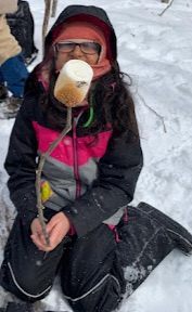 Photo of Macoun Club member who has toasted a marshmallow to golden perfection