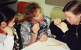Photo of Macoun Club leader Susan Laurie instructing member in art techniques