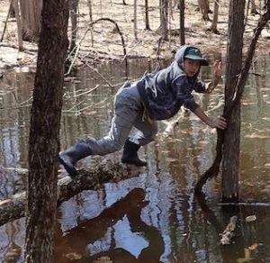 Photo of Macoun Club member pushing the limits on a log over water