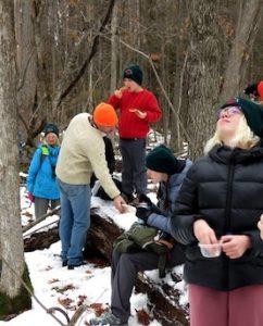 Photo of Macoun Club group having lunch in the snowy woods