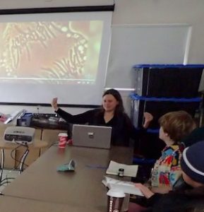Photo of speaker Tamara Checkland giving illustrated talk at a Macoun Field Club meeting