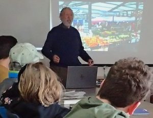 Photo of Roy John giving illustrated presentation at the Macoun Field Clu