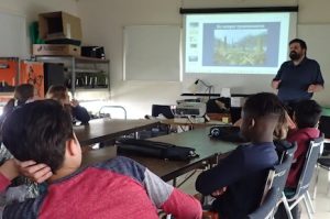 Photo of Robbie Stewart giving a presentation to the kids of the Macoun Club