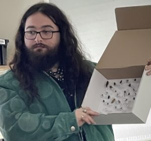 Photo of Rory Hogan exhibiting his insect collection at a Macoun Club meeting