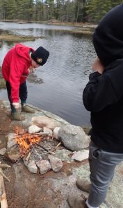 Photo of Macoun Club members tending campfire