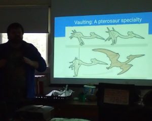 Photo of Robbie Stewart explaining pterosaurs